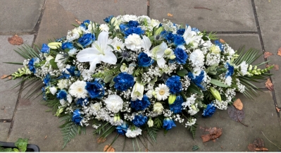 Blue and white casket spray