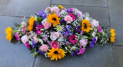 Bright sunflower casket spray