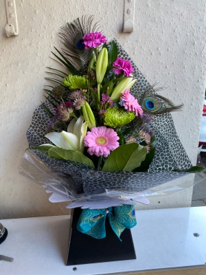 Front facing hand tied with peacock feathers