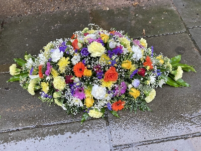 Multi coloured casket spray