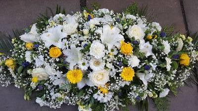 White and yellow casket spray