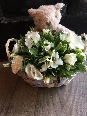 white basket arrangement with bear