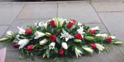 White lily and red rose casket spray