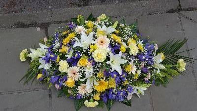 Yellow and blue casket spray