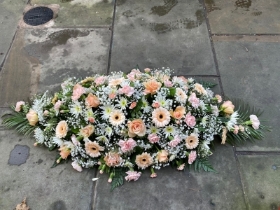 Peach and cream casket spray