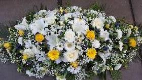 White and yellow casket spray